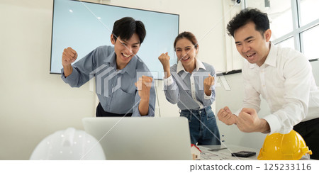 Celebration of Progress and Achievement. A team of architects and engineers cheerfully reacting to project success. 125233116