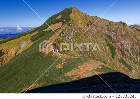 View of Baikabiko hut and Kitamatadake from the climb to Baikabikodake in the Iide mountain range 125233245