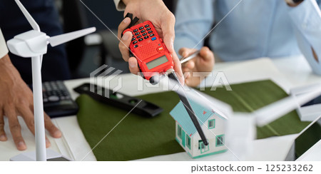 Tools for Sustainable Building Assessment. A professional demonstrating a measurement device for eco-friendly construction. Tools for Sustainable Building Assessment. A professional demonstrating a measurement device for eco-friendly construction. 125233262