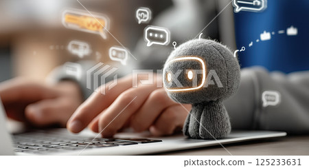 small robot with glowing eyes sits on laptop as person types, surrounded by chat icons 125233631