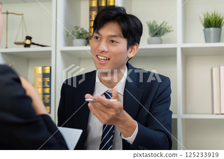 Client Relationships and Legal Strategy. A lawyer explaining points to a client. 125233919