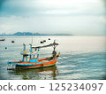 Traditional Thai Fishing Boat Moored by the Coast 125234097