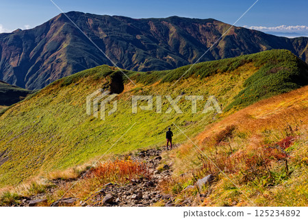 Autumnal Iide mountain range, hikers walking along the main ridgeline and Mt. Dainichi Autumnal Iide mountain range, hikers walking along the main ridgeline and Mt. Dainichi 125234892