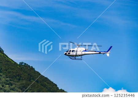 Helicopter scenic flight over Rusutsu Resort, Hokkaido, on a clear summer day 125235446