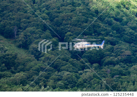 Helicopter scenic flight over Rusutsu Resort, Hokkaido, on a clear summer day 125235448