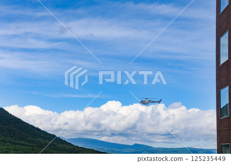 Helicopter scenic flight over Rusutsu Resort, Hokkaido, on a clear summer day Helicopter scenic flight over Rusutsu Resort, Hokkaido, on a clear summer day 125235449