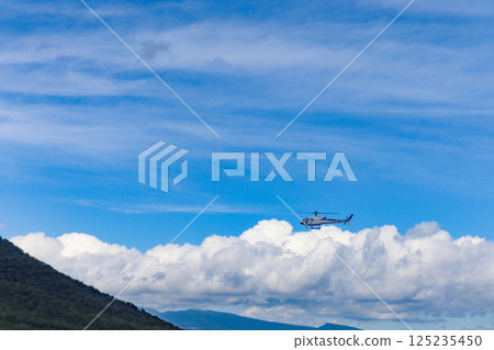 Helicopter scenic flight over Rusutsu Resort, Hokkaido, on a clear summer day 125235450