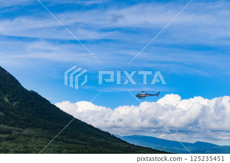 Helicopter scenic flight over Rusutsu Resort, Hokkaido, on a clear summer day 125235451