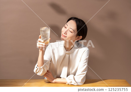 Woman drinking highball brown 125235755