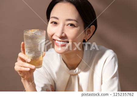 Woman drinking highball brown 125235762