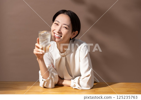 Woman drinking highball brown 125235763