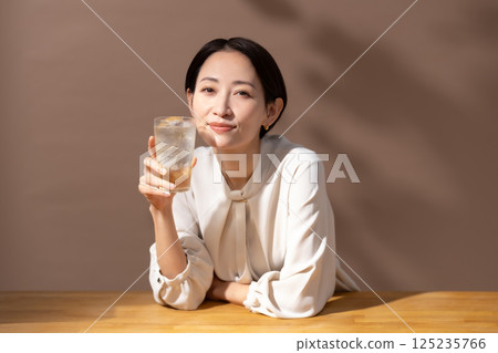 Woman drinking highball brown 125235766