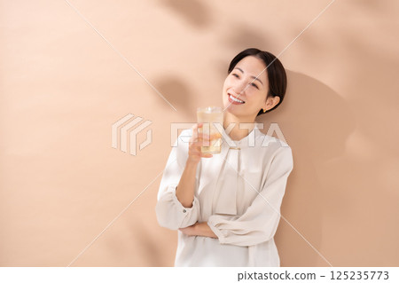 Woman drinking highball, sunlight Woman drinking highball, sunlight 125235773