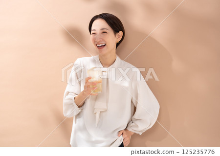 Woman drinking highball, sunlight 125235776