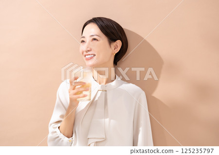 Woman drinking highball, sunlight 125235797