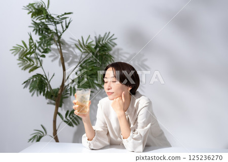 Woman drinking highball Woman drinking highball 125236270