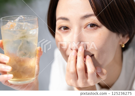 Woman drinking highball Woman drinking highball 125236275