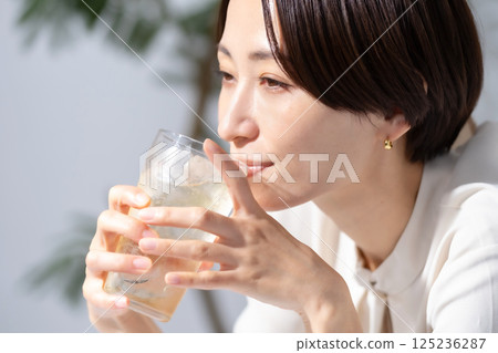 Woman drinking highball Woman drinking highball 125236287