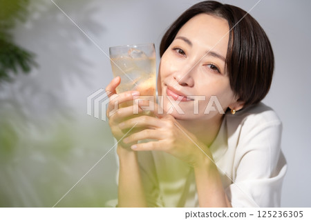 Woman drinking highball Woman drinking highball 125236305