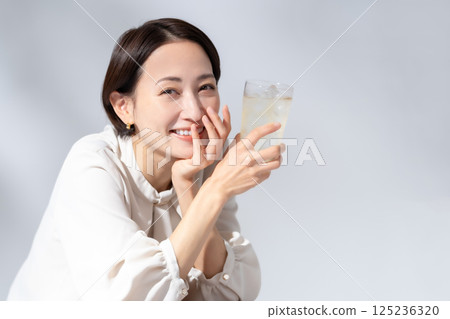 Woman drinking highball Woman drinking highball 125236320