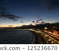 Night view of the seaside town and Ferris wheel sparkling during magic hour 125236670
