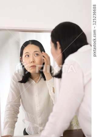 Middle-aged women who are concerned about age spots and fine lines Middle-aged women who are concerned about age spots and fine lines 125236688