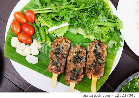 Grilled pork with vegetable on banana leaf. Tradition food of Thailand Grilled pork with vegetable on banana leaf. Tradition food of Thailand 125237045
