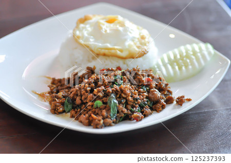 stir fried pork with holy basil , sunny side up egg and rice stir fried pork with holy basil , sunny side up egg and rice 125237393