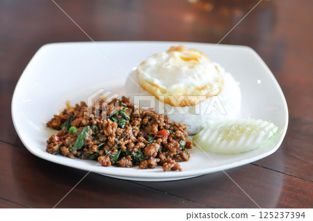 stir fried pork with holy basil , sunny side up egg and rice stir fried pork with holy basil , sunny side up egg and rice 125237394