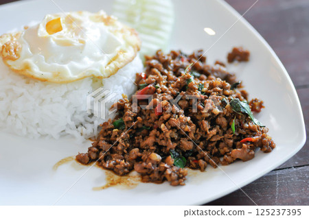stir fried pork with holy basil , sunny side up egg and rice stir fried pork with holy basil , sunny side up egg and rice 125237395