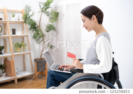 A woman in a wheelchair shopping online 125238851