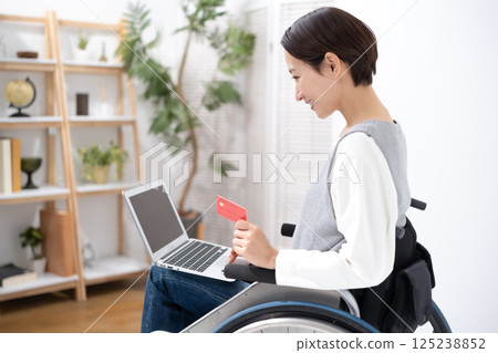 A woman in a wheelchair shopping online 125238852