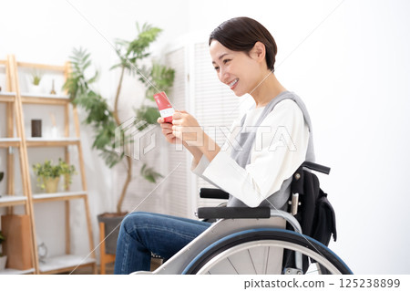 A woman in a wheelchair is happy to see her bankbook 125238899