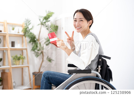 A woman in a wheelchair is happy to see her bankbook 125238906