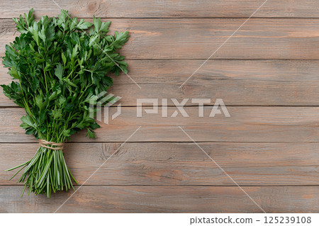 Basil, thyme and parsley bundled with a string on rustic wood, symbolizing culinary preparation Basil, thyme and parsley bundled with a string on rustic wood, symbolizing culinary preparation 125239108