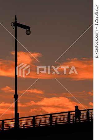 Street lamp on a bridge in the sunset 125239217