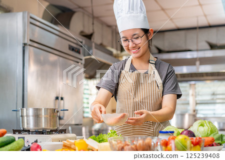 Chef preparing food ingredients  in Professional Kitchen 125239408