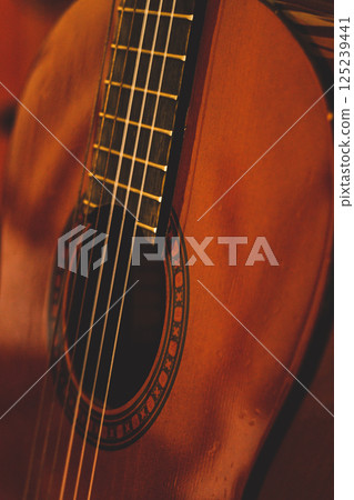 Close-up of a classical guitar with warm lighting 125239441