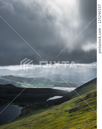 Mountain range with two visible lakes.  A heavy cloud cover casts shadows across the landscape. 125240337