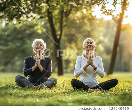 Image of a senior woman meditating in the park 125240419