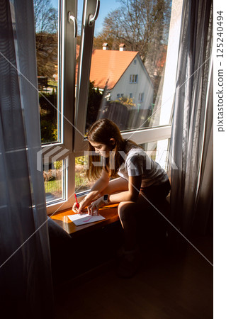 Daughter creating personalized card for mom's birthday, 8 march, mother's day. Children love. Parenthood topic. 125240494