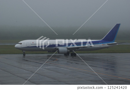 Plane leaving a foggy airport 125241420