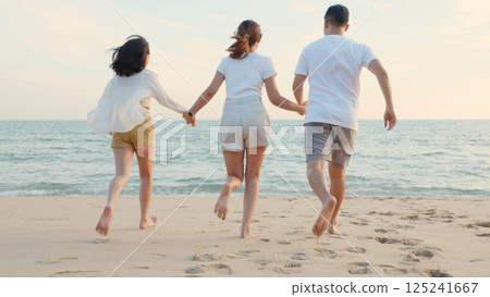 Happy friends holding hands running enjoy life funny and freedom on sand at beach together to sea in holiday vacation time at sunset, Young Asian group woman and man in summer travel, people lifestyle 125241667