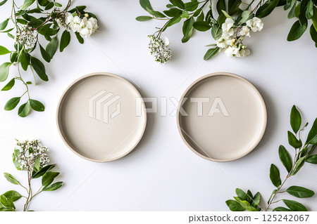 A minimalist dining setup with two plates and floral accents, featuring clean tones and perfect A minimalist dining setup with two plates and floral accents, featuring clean tones and perfect 125242067