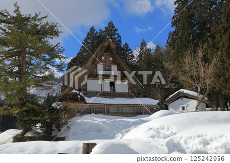 A doll peeking through an open window in a Gassho-style house in Ainokura Gassho-style village 125242956