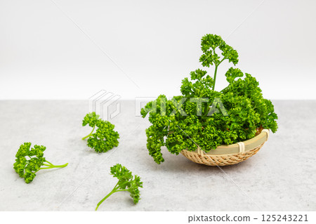 Parsley stock photo: Parsley on a white background in a small colander 125243221