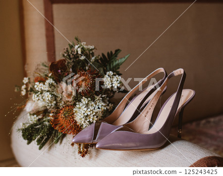Delicate bridal bouquet and pair of elegant heels 125243425