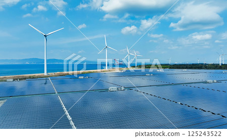 Aerial view of a hybrid power plant with wind turbines and solar panels 125243522