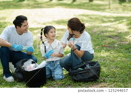 Happy Asian family collecting plastic bottles at the park. 125244657