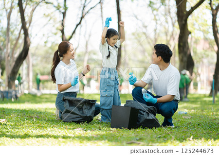 Happy Asian family collecting plastic bottles at the park. 125244673
